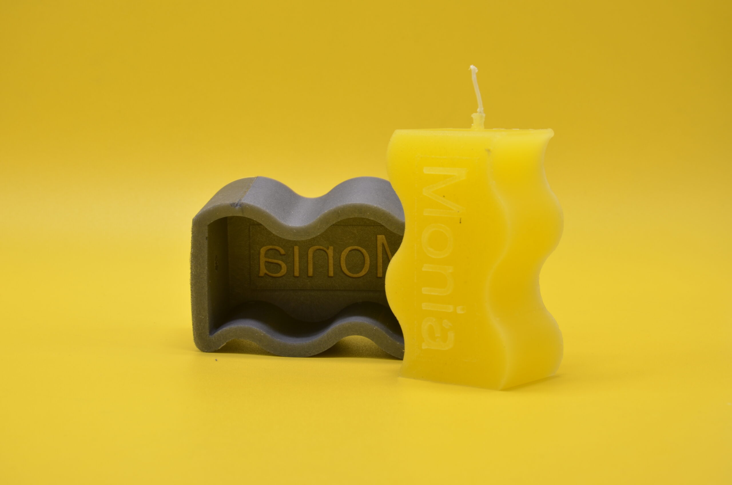 Silikonformen für Logos – Individuelle Silikonform für Kerzen herstellen lassen – Gelbe Form auf gelbem Hintergrund für kreative Gießprojekte.